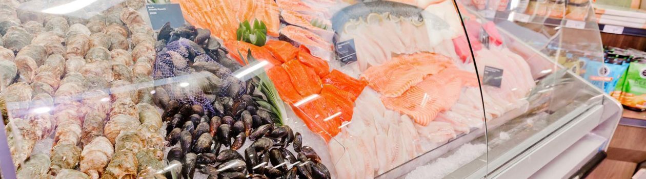 Fully stocked Sobeys seafood case, featuring various fish and shellfish arranged on ice.