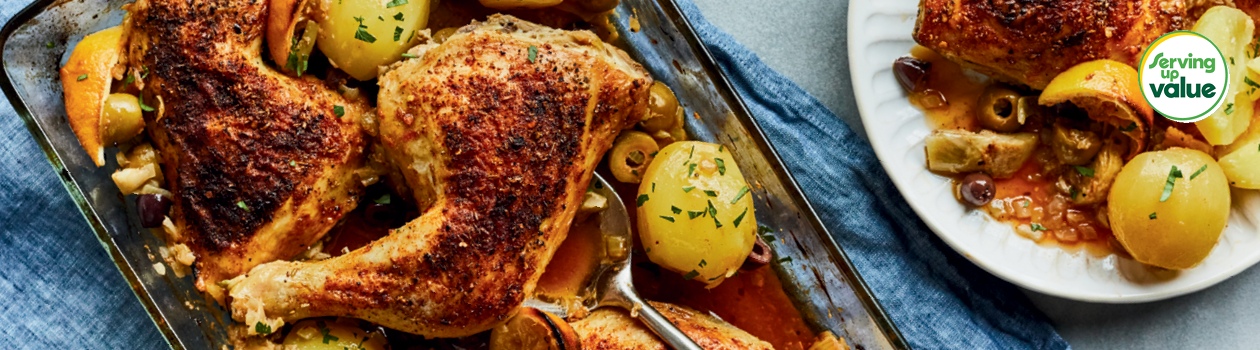 casserole dish of roasted chicken legs with olives and artichokes