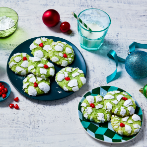 Two plates filled with earthquake cookies and two glasses of milk with festive straws