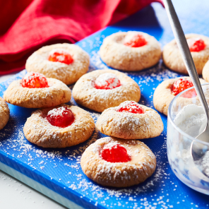 Cherry cheesecake meltaway cookies on a blue cutting board 