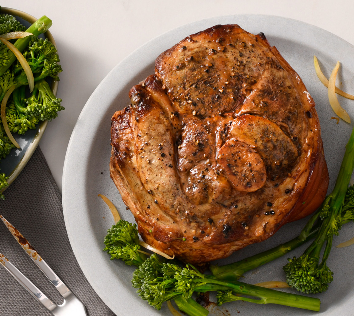 Overhead shot of pork shoulder picnic roast with side of broccoli