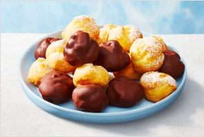 Profiteroles layered on a plate.