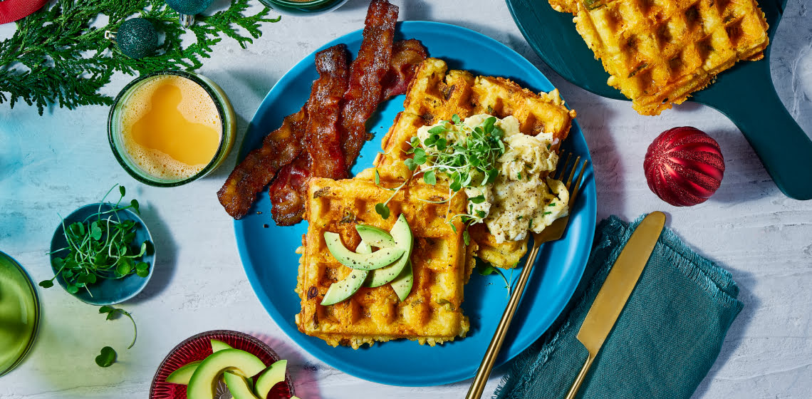 Overhead shot of tater tot waffles with a side of bacon