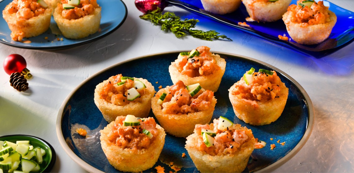 Six breaded shrimp crispy rice cups on a blue plate