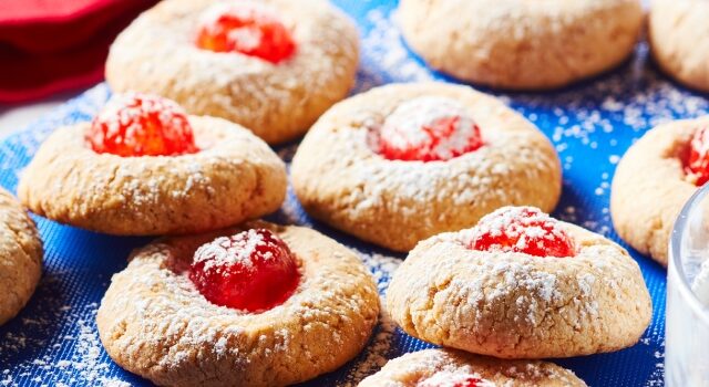 Cherry cheesecake meltaway cookies on a blue cutting board