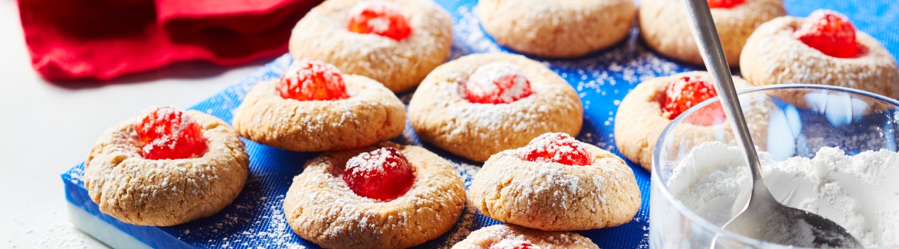 Cherry cheesecake meltaway cookies on a blue cutting board