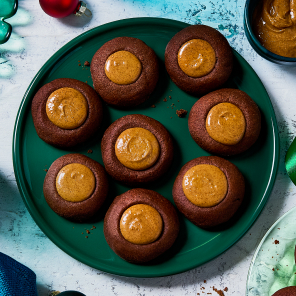 Overhead shot of the thumbprint cookies on a green plate