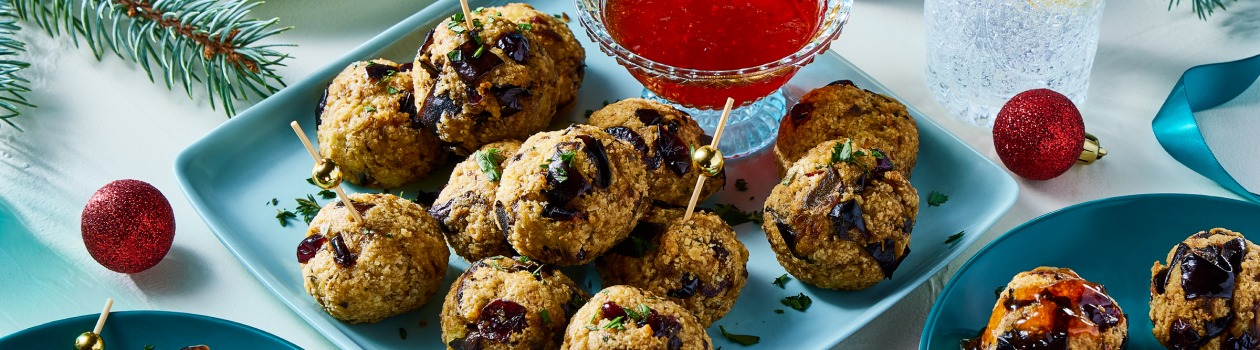 Plate of eggplant “meat”balls with a side of tangy red pepper topping