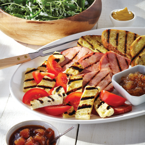 Platter of grilled halloumi, ham and tomatoes.