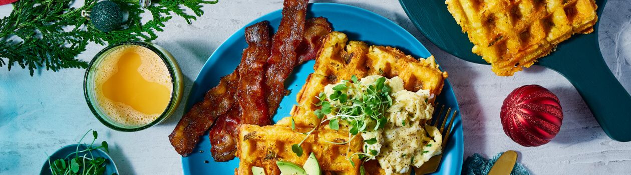 Overhead shot of tater tot waffles with a side of bacon