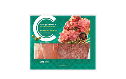 Clear plastic package of Compliments Charcuterie Trio (Dry-Cured Genoa Salami, Salami with Prosciutto & Prosciutto) with green label.