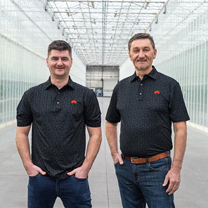 Nature Fresh Farms Peter Quiring and Matt Quiring posing a greenhouse