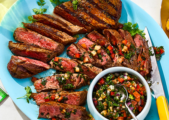 The plate in the centre has the tri tip steak sliced with the salsa on top and in a small bowl with two other plates surrounding it, one with potatoes and one with a combination of the sliced steak with salsa and more potatoes.