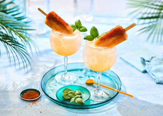 Guava popsicle cocktails with guava pop as a garnish