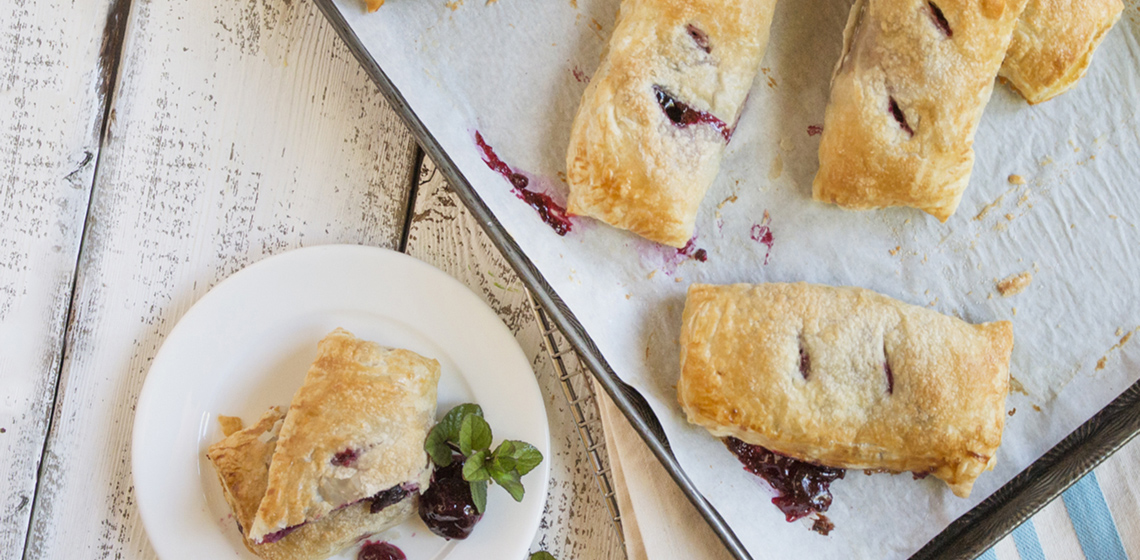 Cherry hand pie on a plate.