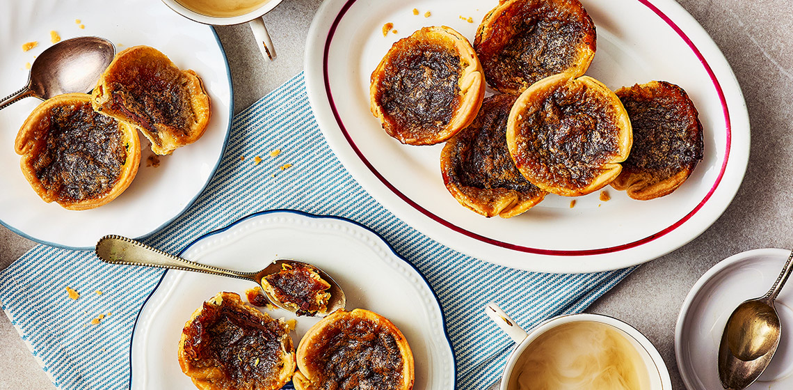 Overhead shot of plate of chocolate caramel butter tarts
