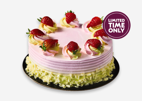 Strawberry Lemonade Cake - pink frosted cake topped with strawberries.