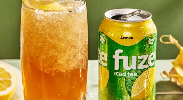 Lemon iced tea is served over crushed ice with a lemon twist.