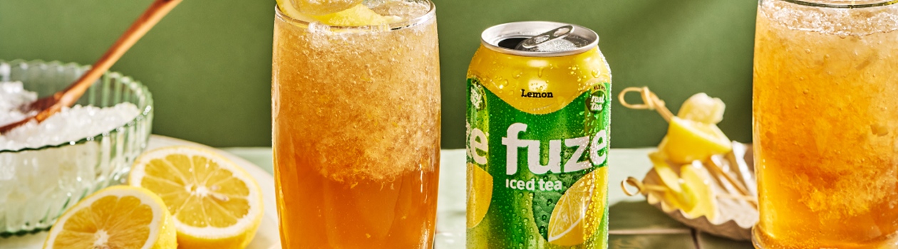 Lemon iced tea is served over crushed ice with a lemon twist.